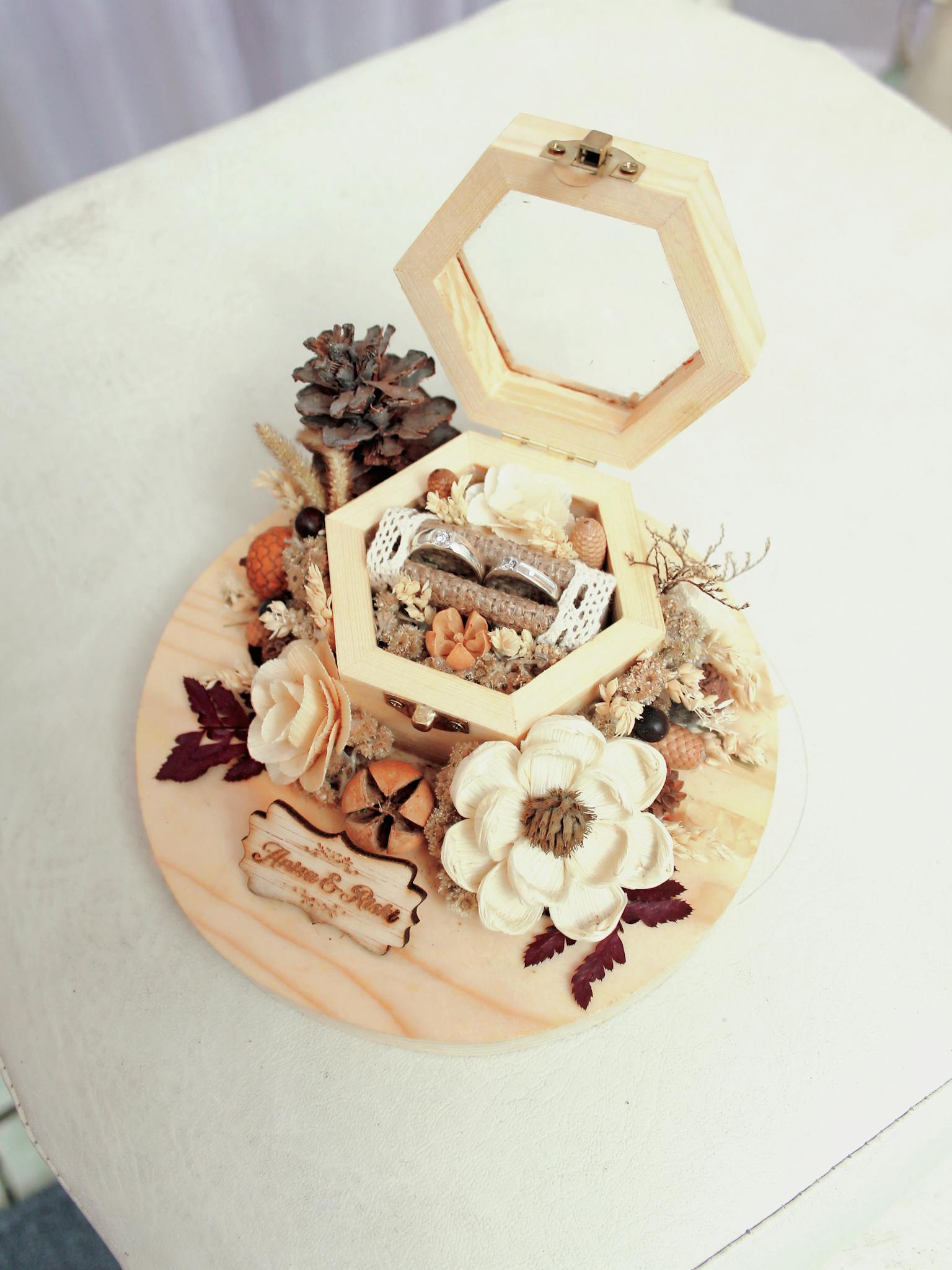 Beautiful wooden ring box surrounded by natural florals for weddings.