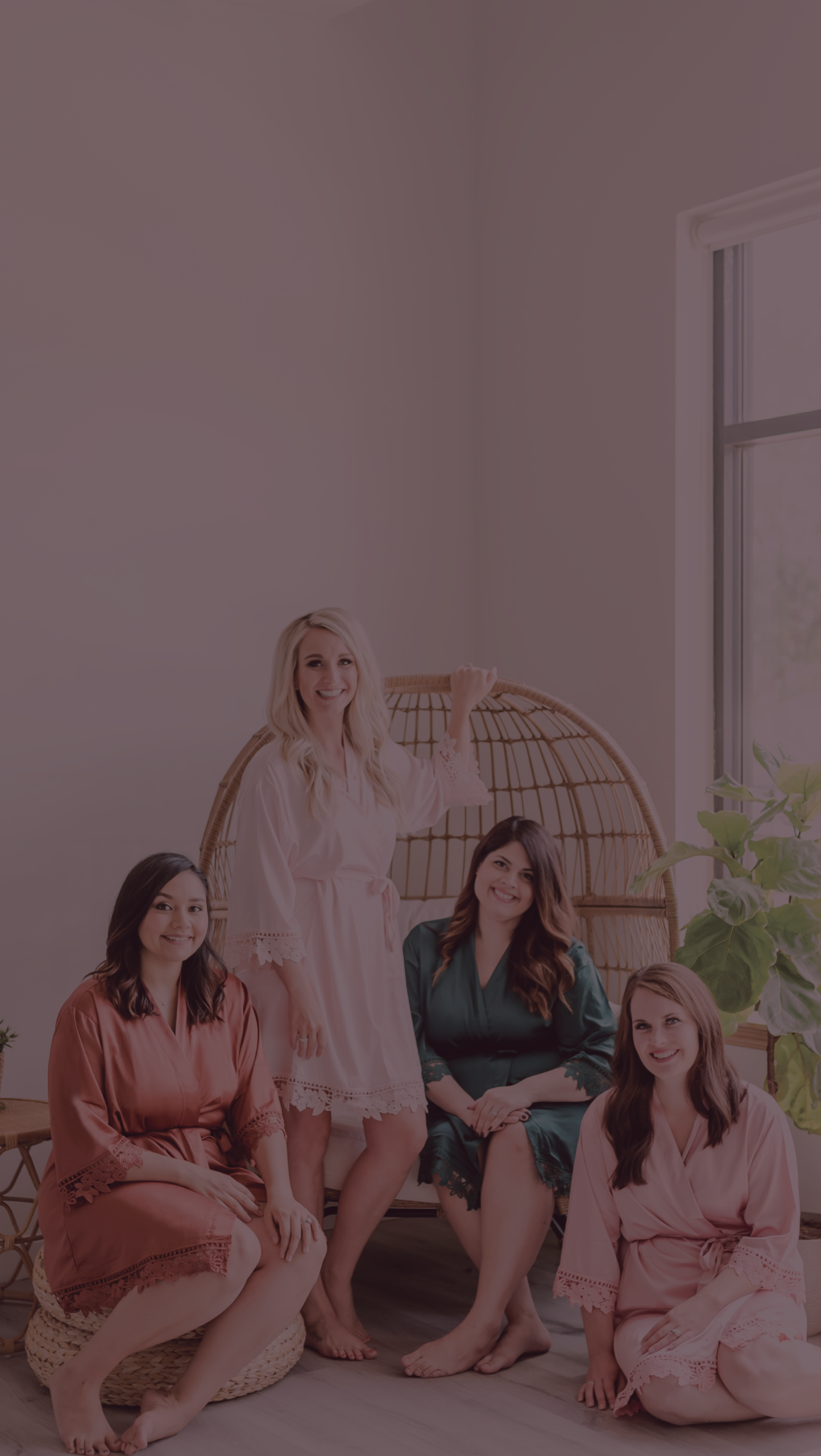 Group of bridesmaids posing in their bridesmaid robes.
